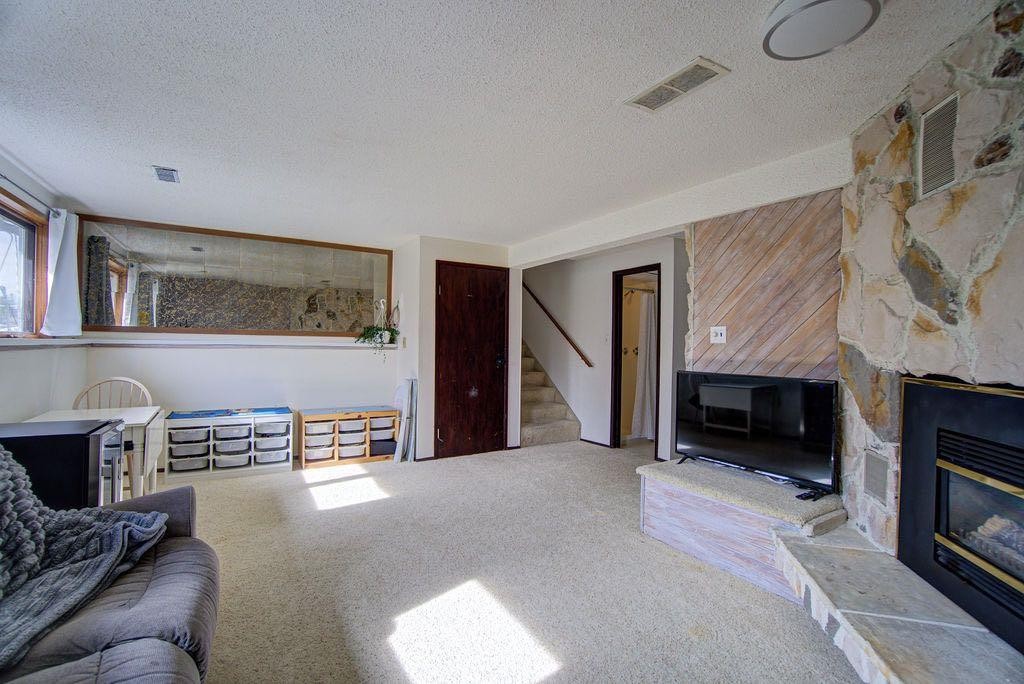 47 Willow Road, Claresholm, AB - Indoor Photo Showing Living Room With Fireplace