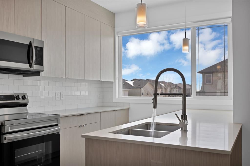 105 Panatella Square Nw, Calgary, AB - Indoor Photo Showing Kitchen With Double Sink With Upgraded Kitchen