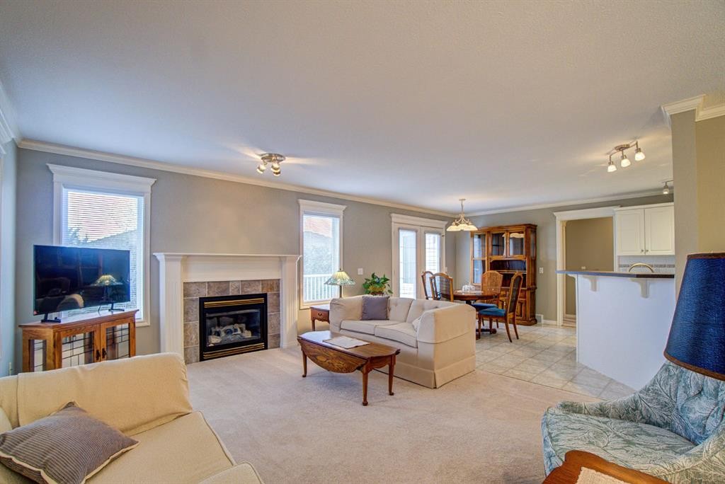 26 Skyline Crescent, Claresholm, AB - Indoor Photo Showing Living Room With Fireplace