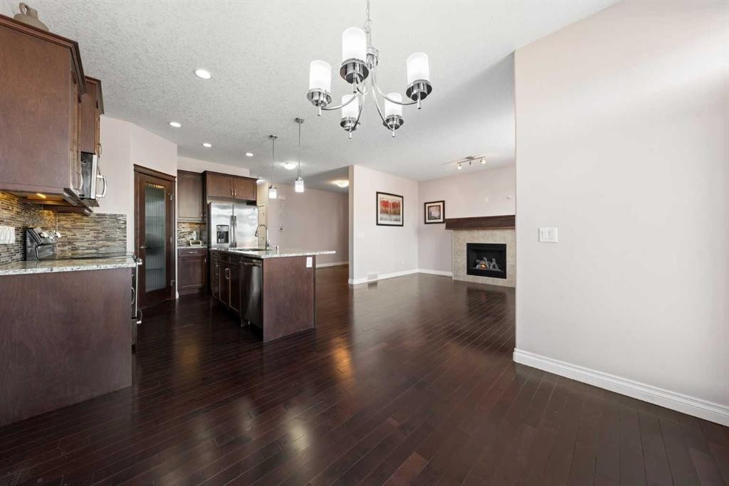 529 Saddlelake Drive Ne, Calgary, AB - Indoor Photo Showing Kitchen With Fireplace
