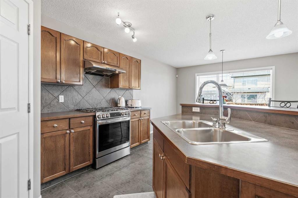 8 Chapalina Rise Se, Calgary, AB - Indoor Photo Showing Kitchen With Double Sink