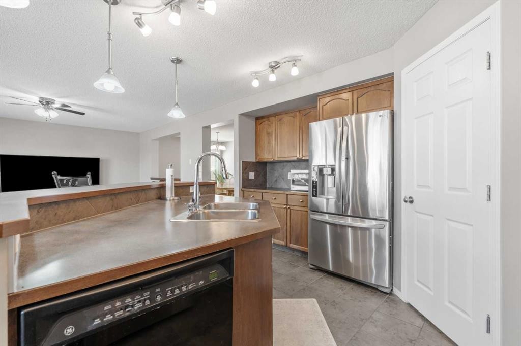 8 Chapalina Rise Se, Calgary, AB - Indoor Photo Showing Kitchen With Double Sink