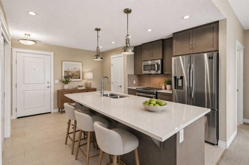 207-39 Quarry Gate Se, Calgary, AB - Indoor Photo Showing Kitchen With Stainless Steel Kitchen With Double Sink With Upgraded Kitchen