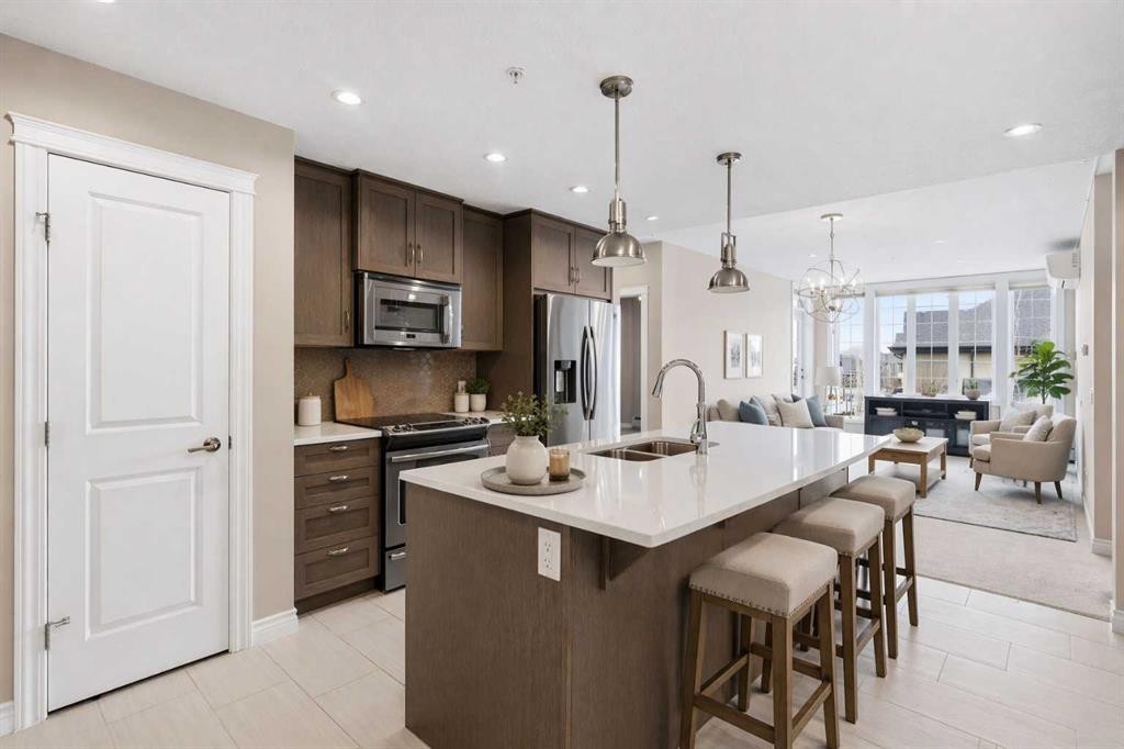 207-39 Quarry Gate Se, Calgary, AB - Indoor Photo Showing Kitchen With Stainless Steel Kitchen With Double Sink With Upgraded Kitchen