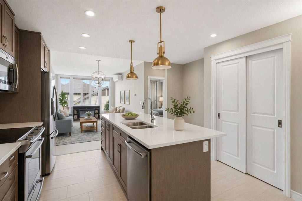 207-39 Quarry Gate Se, Calgary, AB - Indoor Photo Showing Kitchen With Stainless Steel Kitchen With Double Sink With Upgraded Kitchen