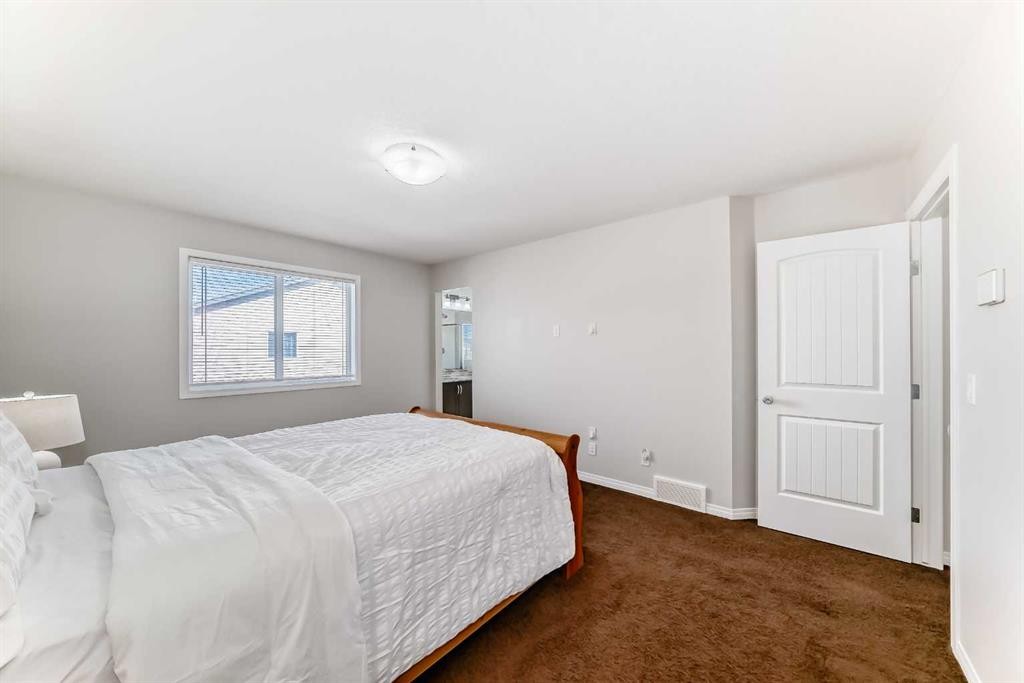 795 New Brighton Drive Se, Calgary, AB - Indoor Photo Showing Bedroom