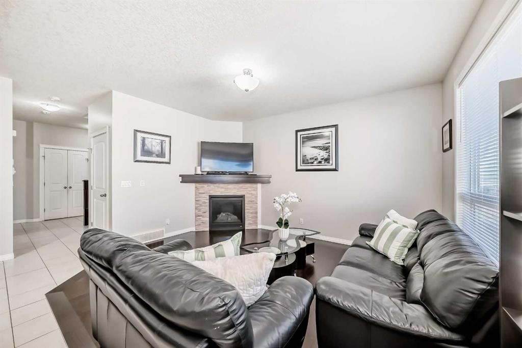 795 New Brighton Drive Se, Calgary, AB - Indoor Photo Showing Living Room With Fireplace