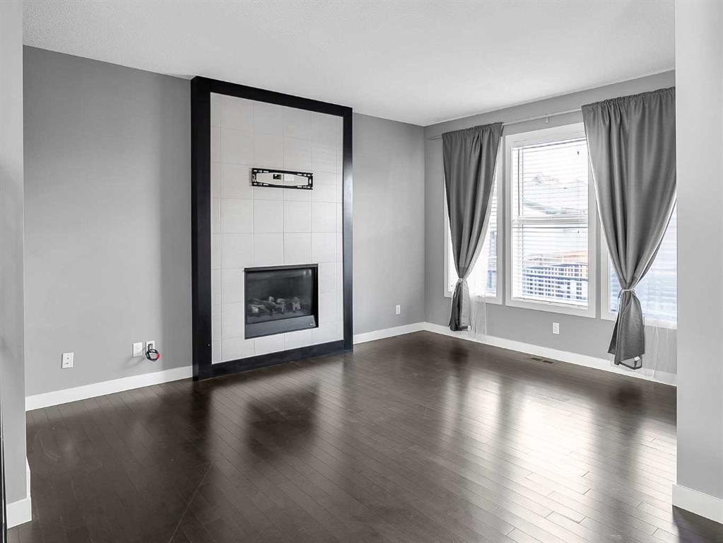 23 Marquis Link Se, Calgary, AB - Indoor Photo Showing Other Room With Fireplace
