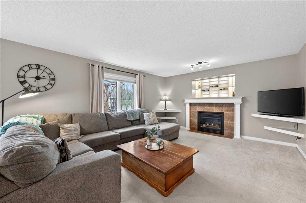 127 Hidden Ranch Terrace Nw, Calgary, AB - Indoor Photo Showing Living Room With Fireplace