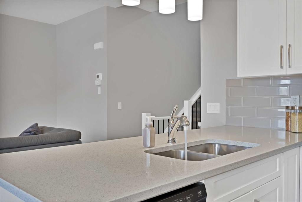 1167 Channelside Drive Sw, Airdrie, AB - Indoor Photo Showing Kitchen With Double Sink