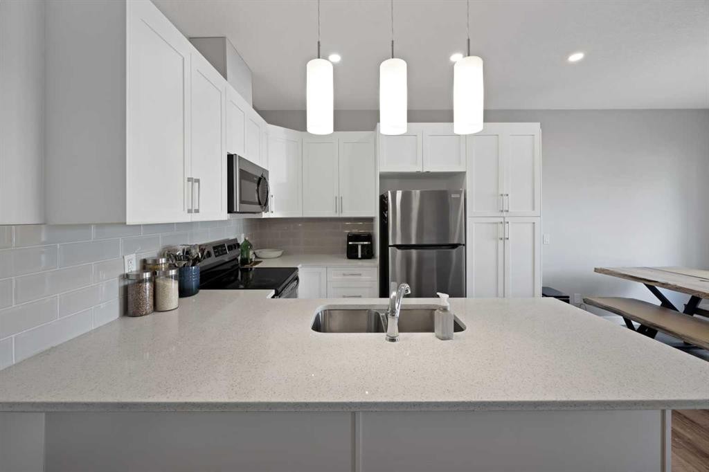 1167 Channelside Drive Sw, Airdrie, AB - Indoor Photo Showing Kitchen With Double Sink With Upgraded Kitchen