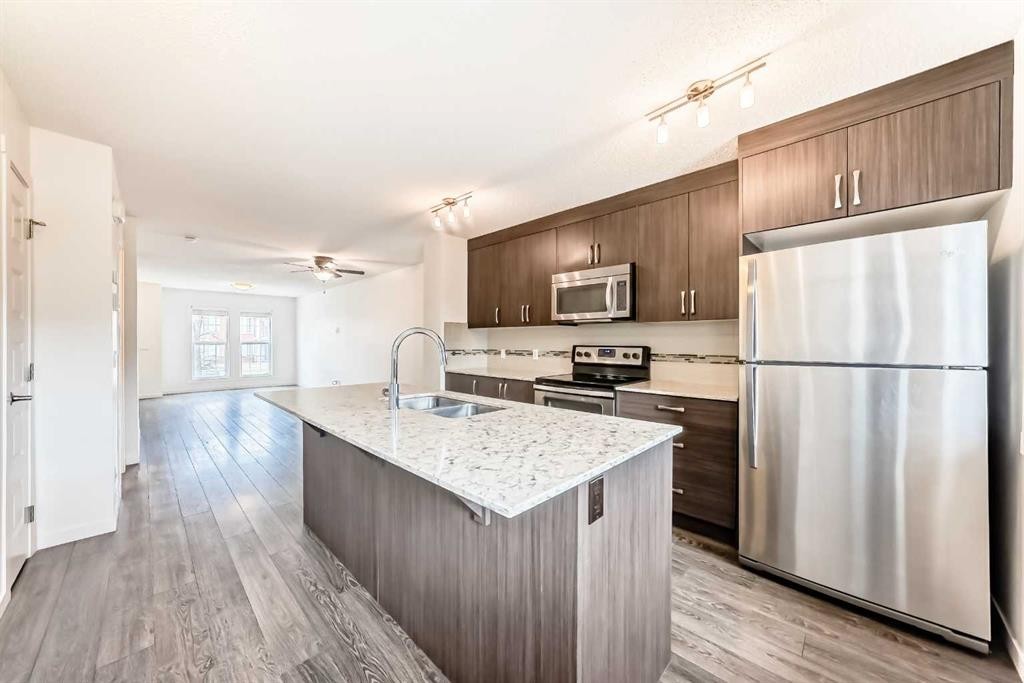 56 Auburn Bay Link Se, Calgary, AB - Indoor Photo Showing Kitchen With Stainless Steel Kitchen With Double Sink With Upgraded Kitchen