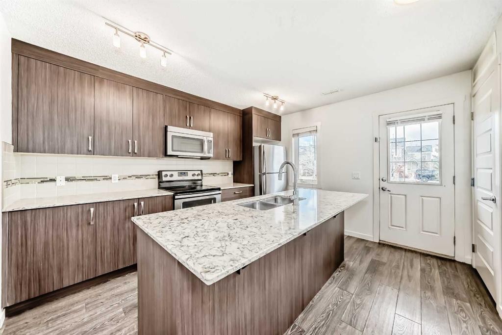 56 Auburn Bay Link Se, Calgary, AB - Indoor Photo Showing Kitchen With Stainless Steel Kitchen With Double Sink With Upgraded Kitchen