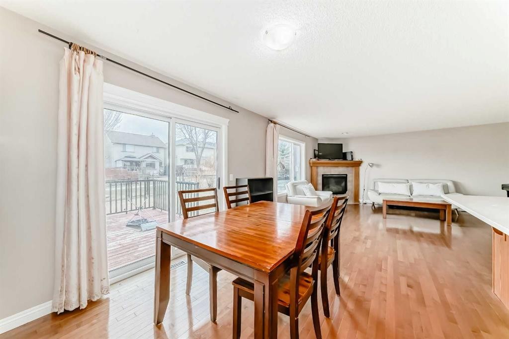 264 Everwillow Green Sw, Calgary, AB - Indoor Photo Showing Dining Room With Fireplace
