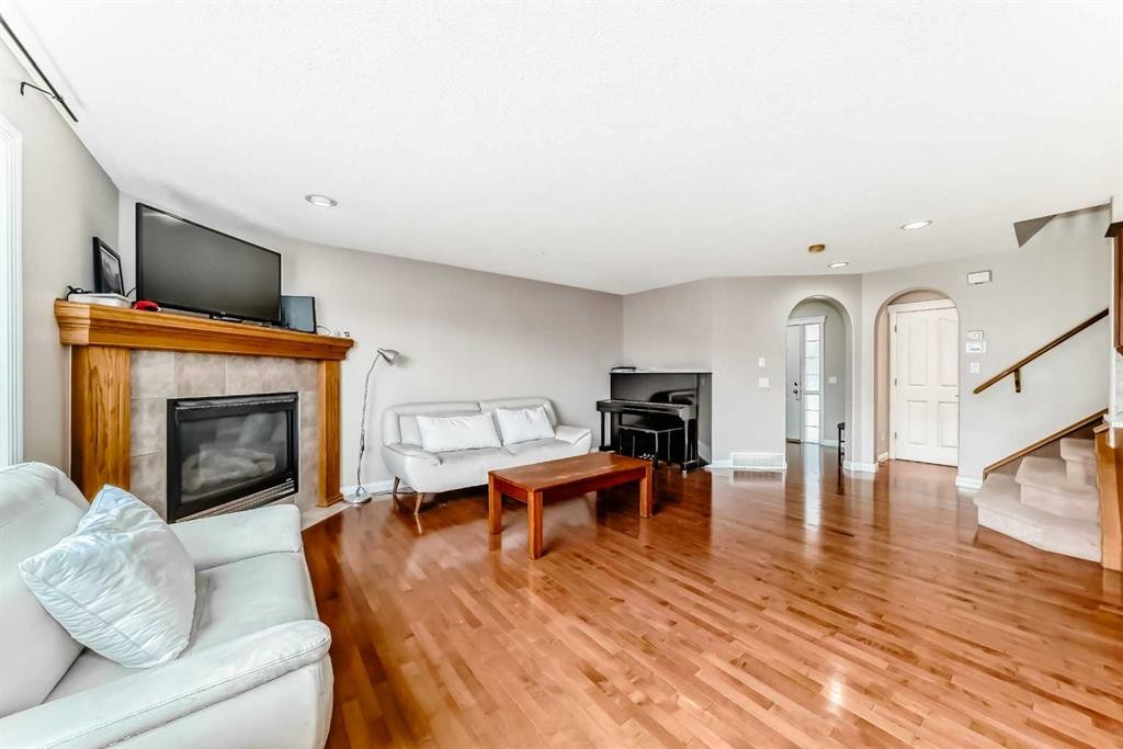 264 Everwillow Green Sw, Calgary, AB - Indoor Photo Showing Living Room With Fireplace