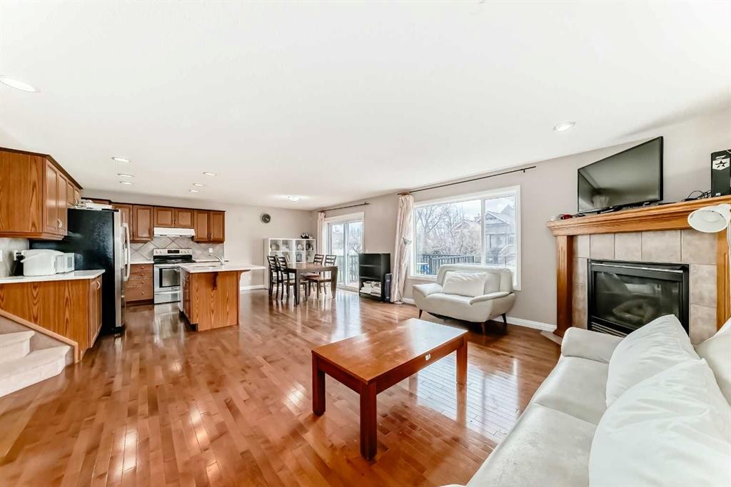 264 Everwillow Green Sw, Calgary, AB - Indoor Photo Showing Living Room With Fireplace