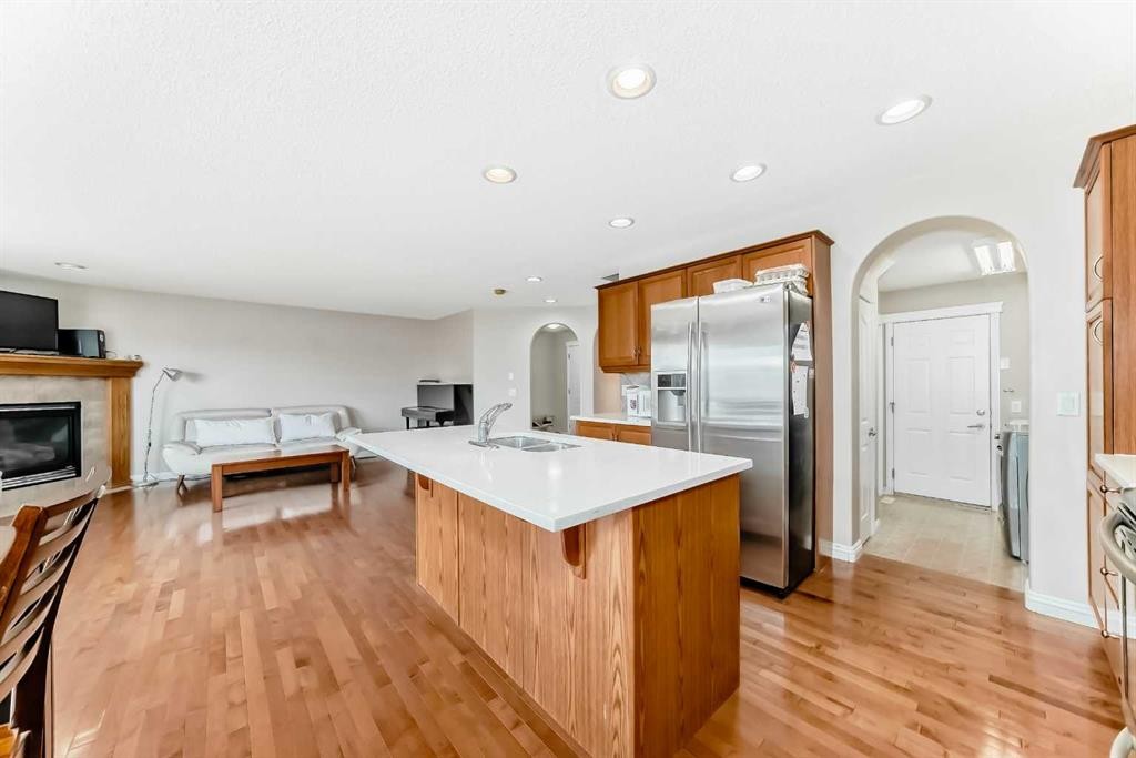 264 Everwillow Green Sw, Calgary, AB - Indoor Photo Showing Kitchen With Fireplace