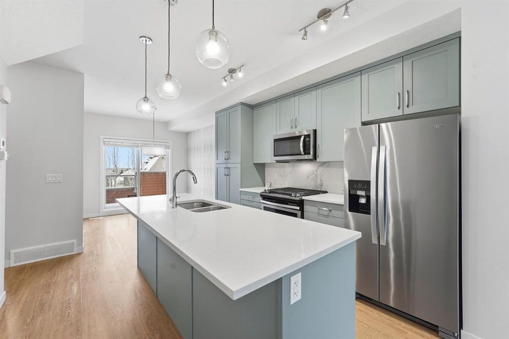 84 Shawnee Common Sw, Calgary, AB - Indoor Photo Showing Kitchen With Stainless Steel Kitchen With Double Sink With Upgraded Kitchen
