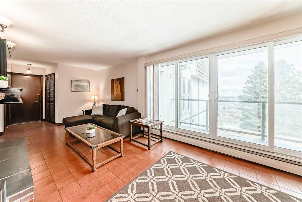 201-512 Cedar Crescent Sw, Calgary, AB - Indoor Photo Showing Other Room With Fireplace