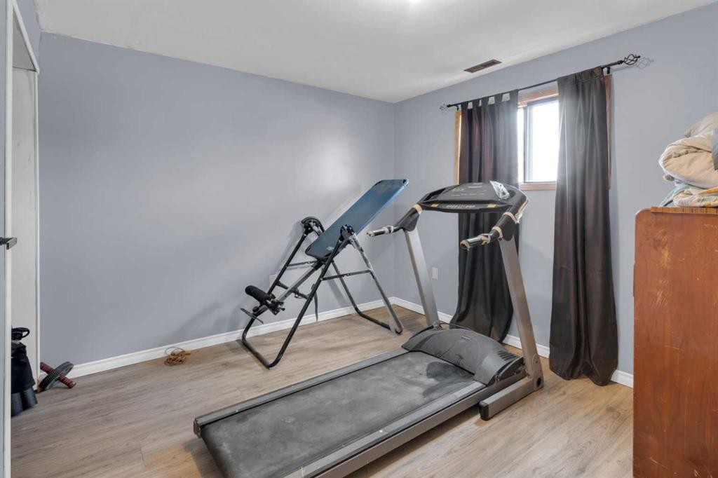 23 Beaver Place, Beiseker, AB - Indoor Photo Showing Gym Room