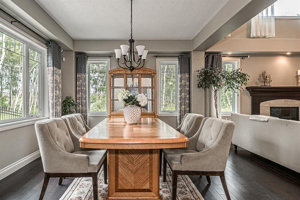 180 Ascot Drive Sw, Calgary, AB - Indoor Photo Showing Dining Room With Fireplace