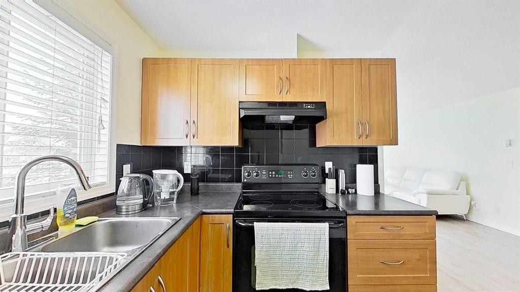 1202-2395 Eversyde Avenue Sw, Calgary, AB - Indoor Photo Showing Kitchen With Double Sink