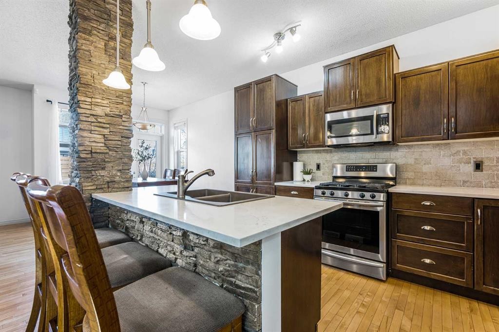 76 Heritage Hill, Cochrane, AB - Indoor Photo Showing Kitchen With Stainless Steel Kitchen With Double Sink