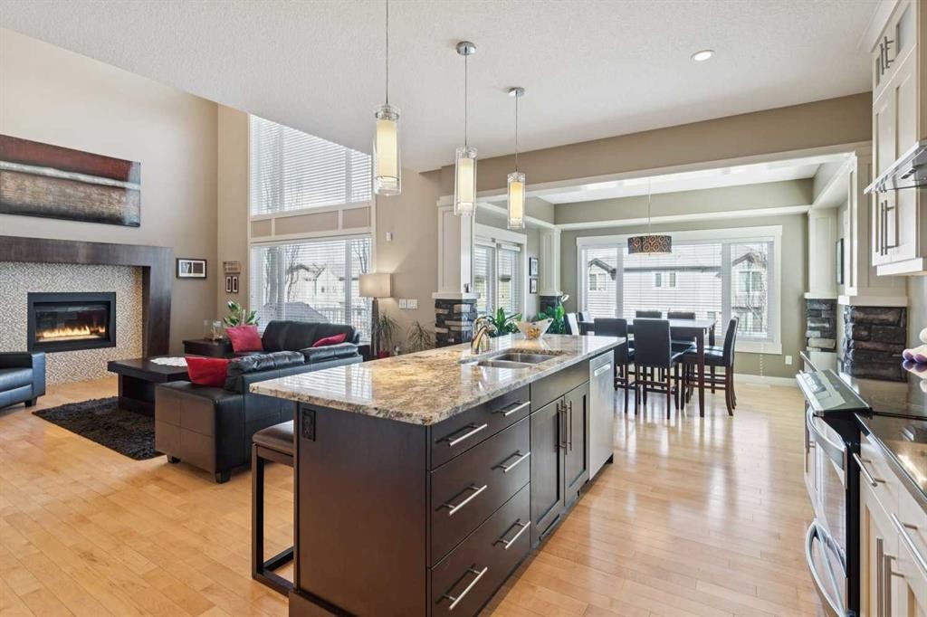 44 Aspen Summit Drive Sw, Calgary, AB - Indoor Photo Showing Kitchen With Fireplace With Double Sink With Upgraded Kitchen
