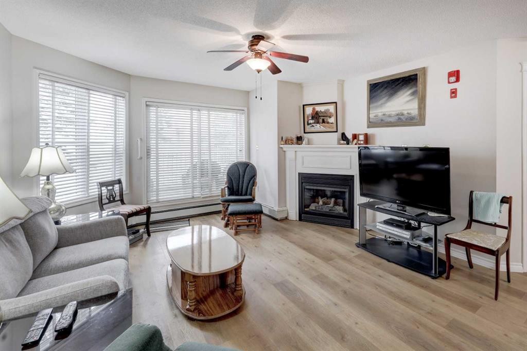 101-6800 Hunterview Drive Nw, Calgary, AB - Indoor Photo Showing Living Room With Fireplace