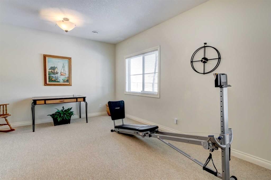 55 Tucker Circle, Okotoks, AB - Indoor Photo Showing Gym Room