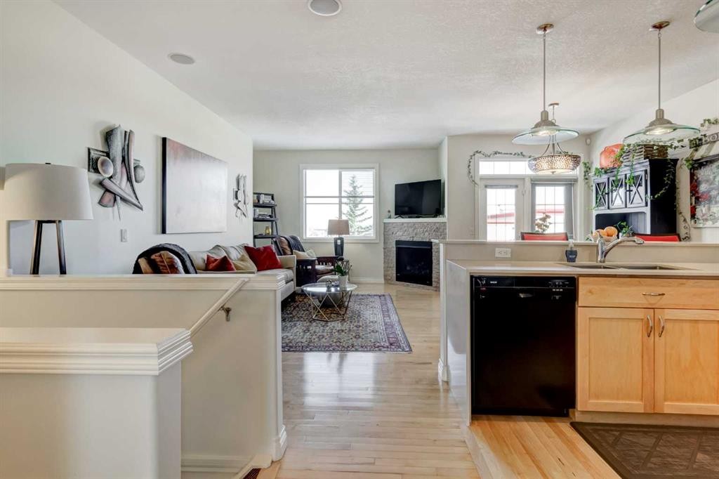55 Tucker Circle, Okotoks, AB - Indoor Photo Showing Kitchen With Fireplace