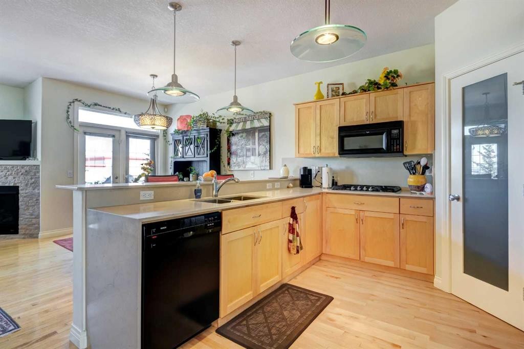 55 Tucker Circle, Okotoks, AB - Indoor Photo Showing Kitchen With Fireplace With Double Sink