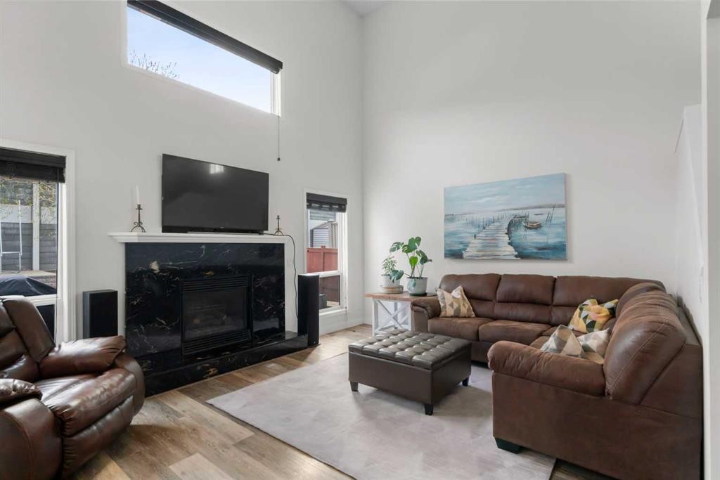 176 Douglas Ridge Green Se, Calgary, AB - Indoor Photo Showing Living Room With Fireplace