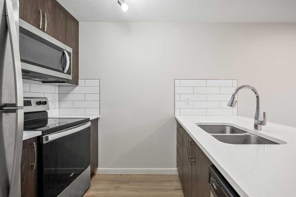 167 Cranbrook Square Se, Calgary, AB - Indoor Photo Showing Kitchen With Double Sink