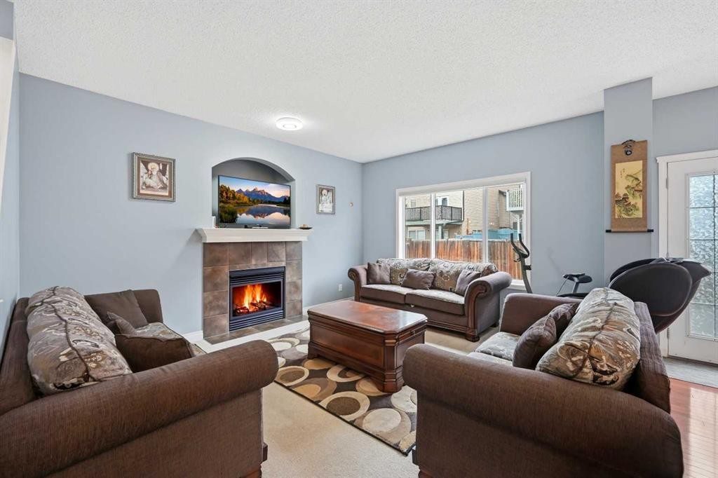61 Saddleland Drive Ne, Calgary, AB - Indoor Photo Showing Living Room With Fireplace