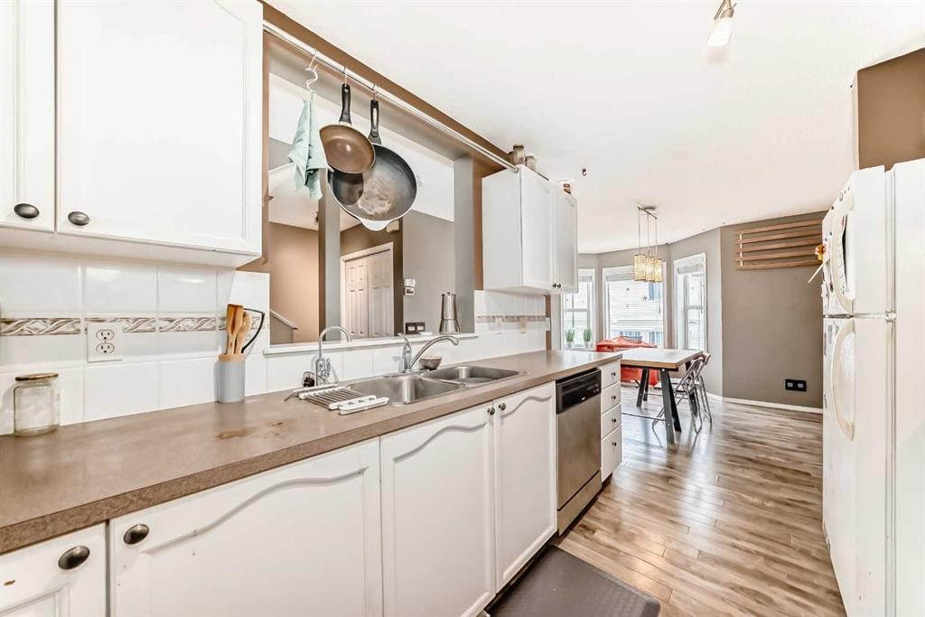 112 Country Village Cape Ne, Calgary, AB - Indoor Photo Showing Kitchen With Double Sink
