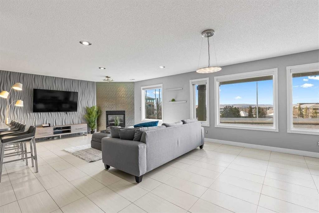 12 Arbour Estates Green Nw, Calgary, AB - Indoor Photo Showing Living Room With Fireplace