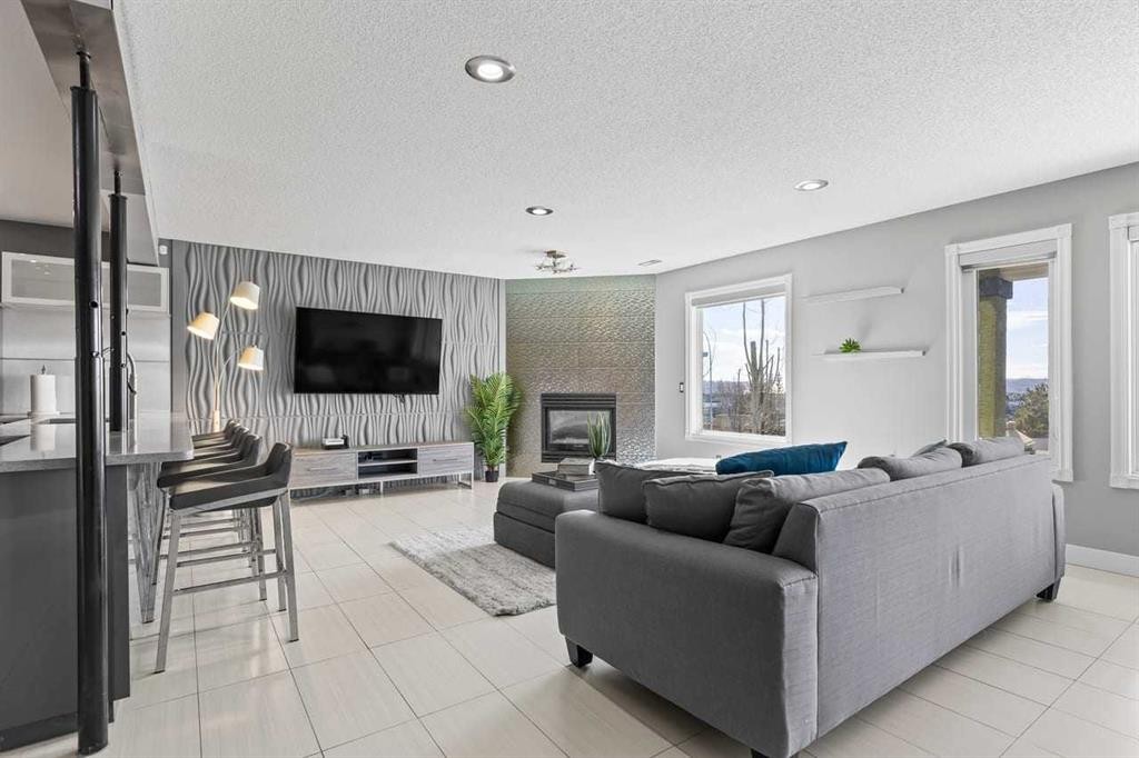12 Arbour Estates Green Nw, Calgary, AB - Indoor Photo Showing Living Room With Fireplace