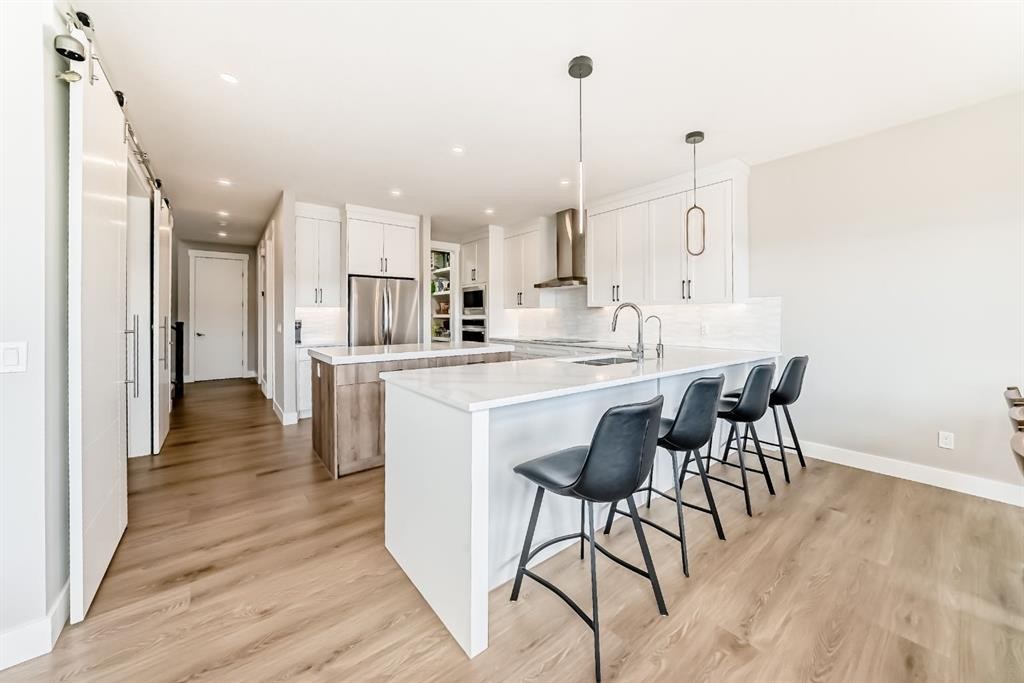 80 Vantage Drive, Cochrane, AB - Indoor Photo Showing Kitchen With Double Sink With Upgraded Kitchen