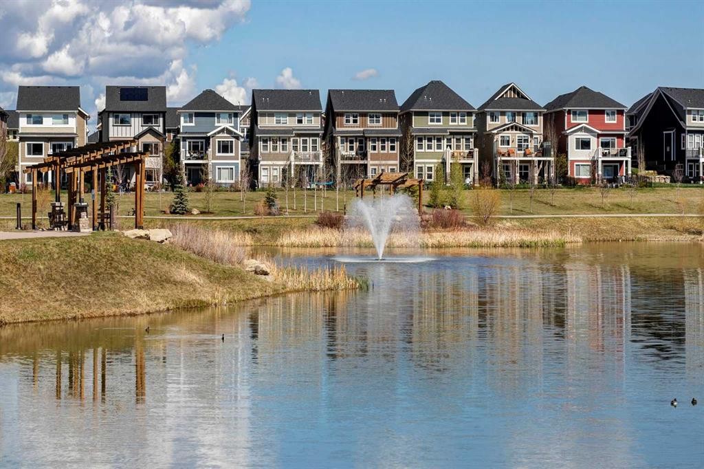 140 Sundown Road, Cochrane, AB - Outdoor With Body Of Water With Facade