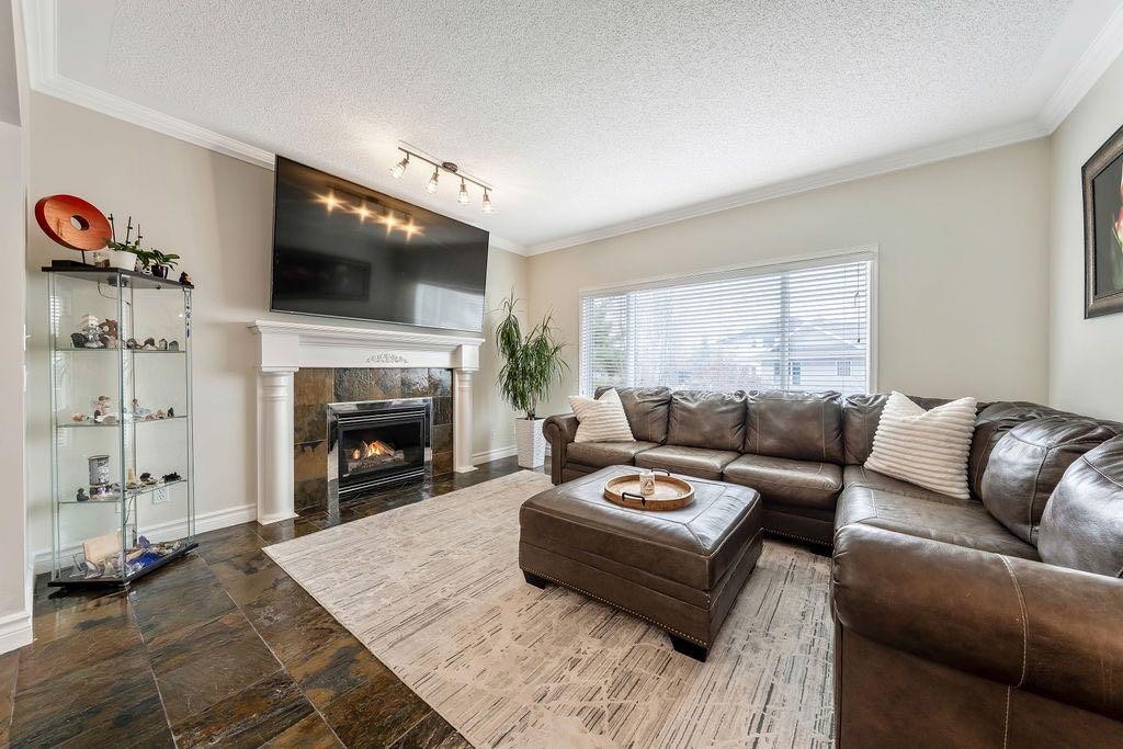 4 Cimarron Trail, Okotoks, AB - Indoor Photo Showing Living Room With Fireplace