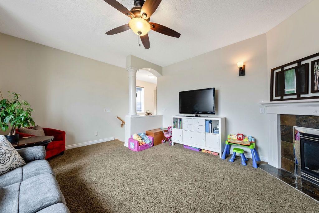 4 Cimarron Trail, Okotoks, AB - Indoor Photo Showing Living Room With Fireplace