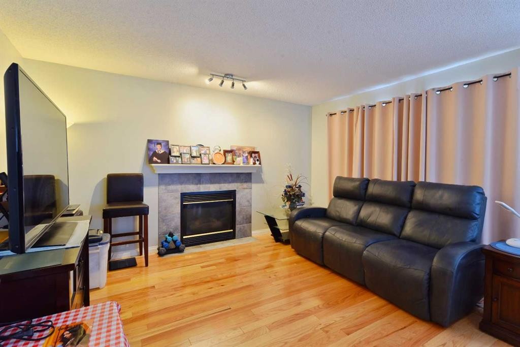 105 Coral Springs Close Ne, Calgary, AB - Indoor Photo Showing Living Room With Fireplace