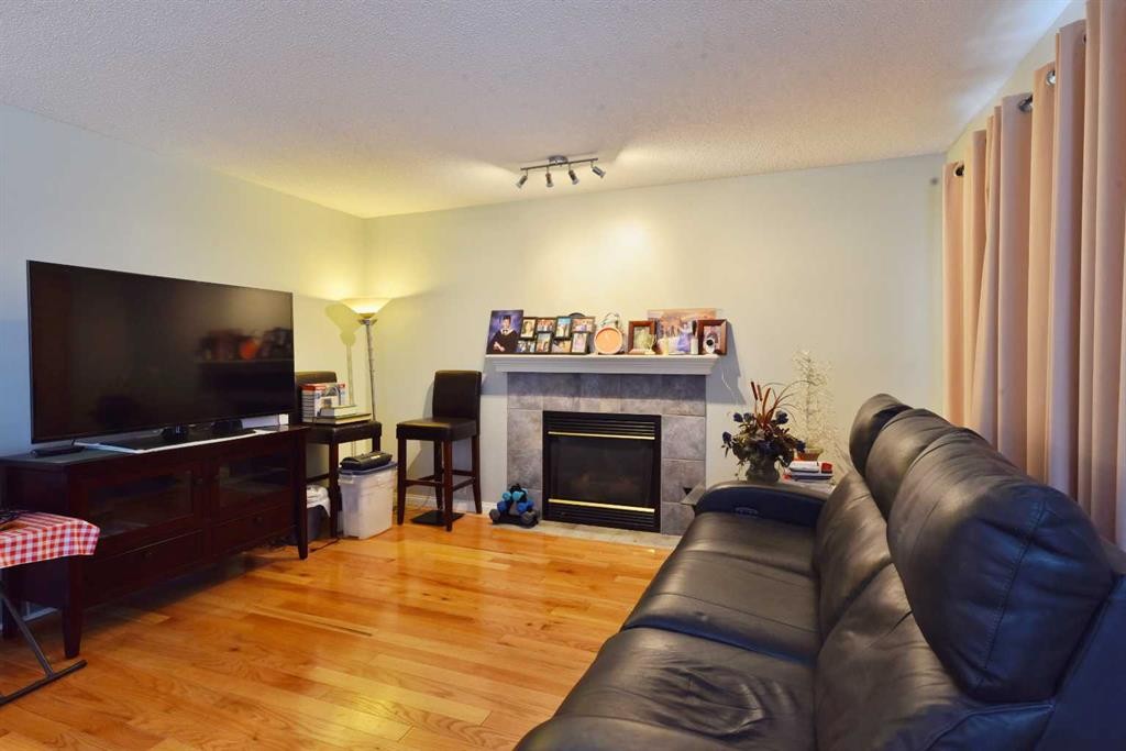 105 Coral Springs Close Ne, Calgary, AB - Indoor Photo Showing Living Room With Fireplace