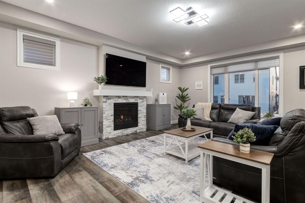 166 Osborne Common Sw, Airdrie, AB - Indoor Photo Showing Living Room With Fireplace