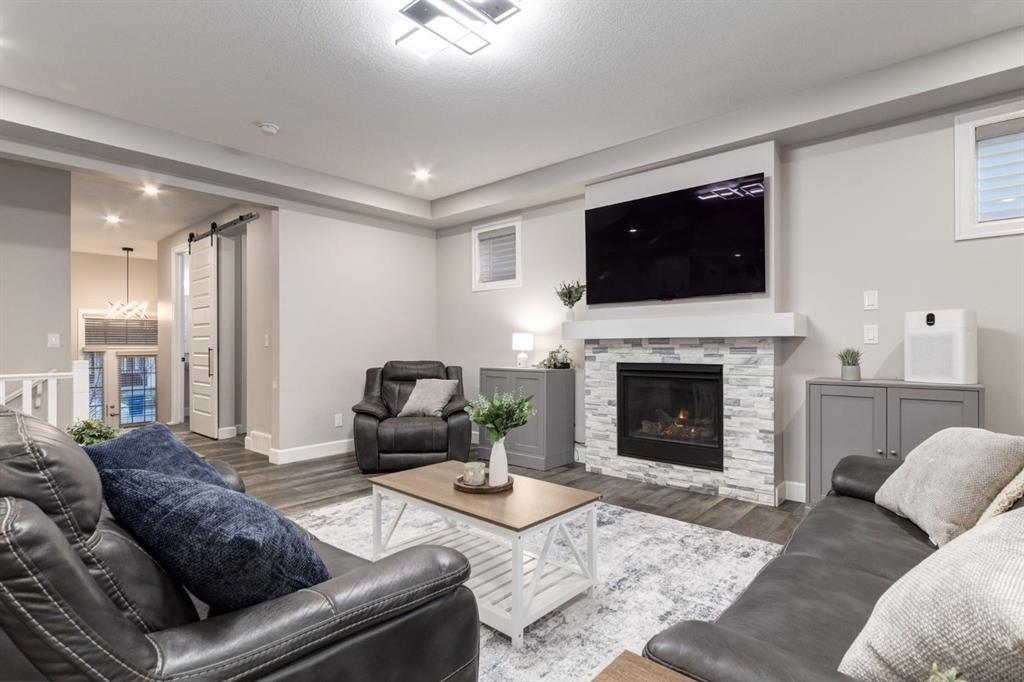 166 Osborne Common Sw, Airdrie, AB - Indoor Photo Showing Living Room With Fireplace