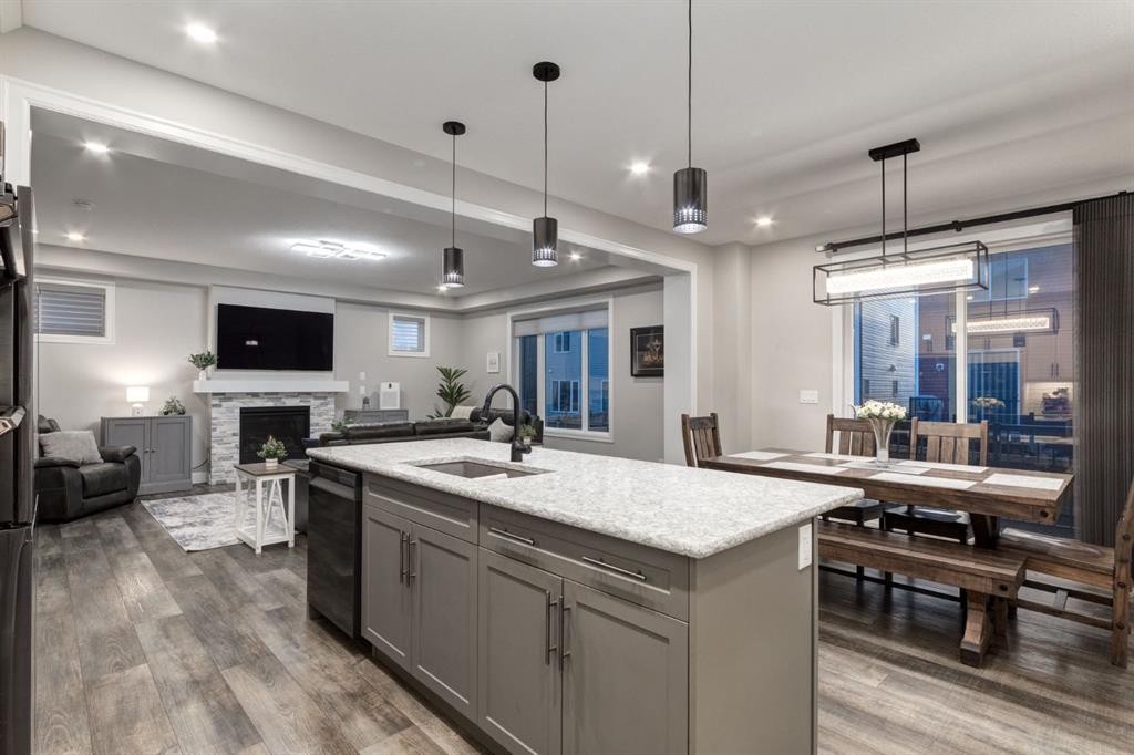 166 Osborne Common Sw, Airdrie, AB - Indoor Photo Showing Kitchen With Fireplace