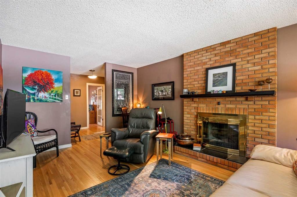 5 Fraser Road Se, Calgary, AB - Indoor Photo Showing Living Room With Fireplace