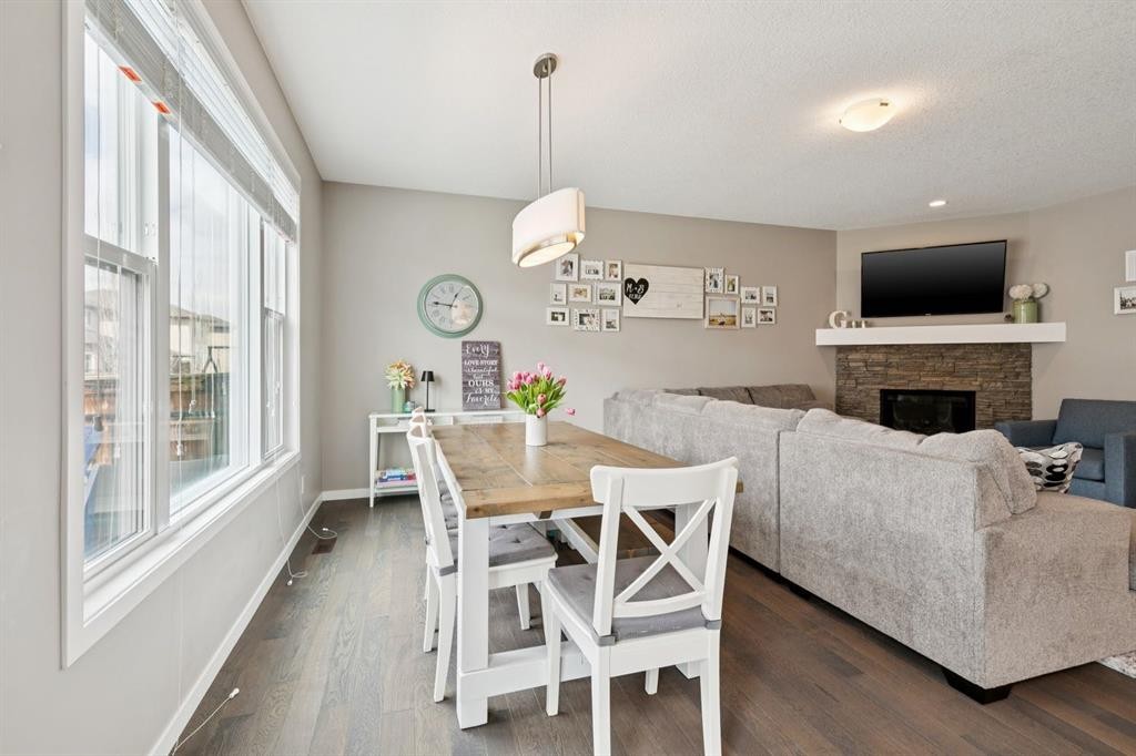 80 Brightoncrest Point Se, Calgary, AB - Indoor Photo Showing Dining Room With Fireplace