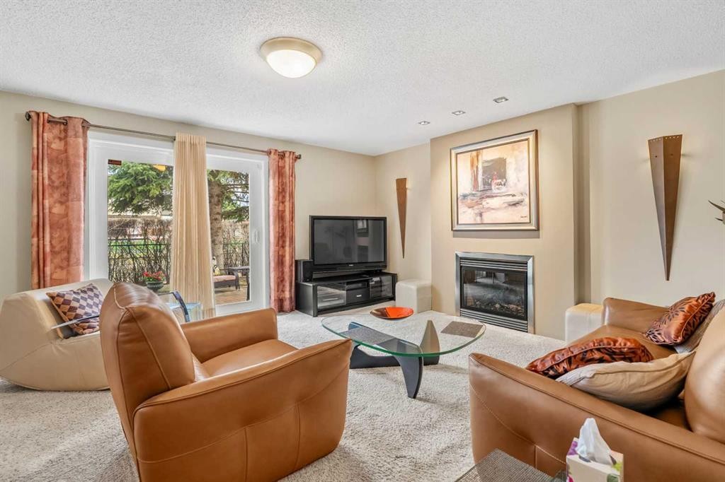 91 Sun Valley Drive Se, Calgary, AB - Indoor Photo Showing Living Room With Fireplace
